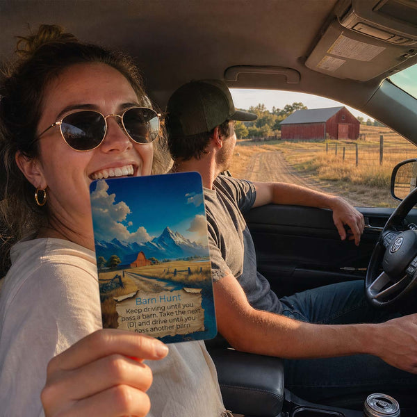 Couple by their car on a country drive with a Destination Unknown card